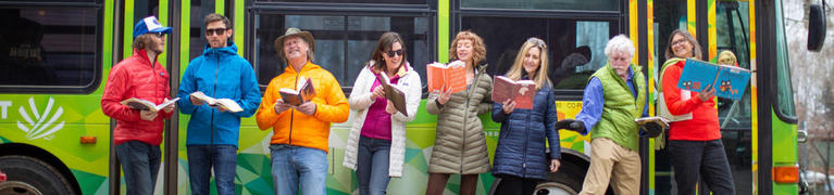 Librarians Reading Books in front of a SMART Bus